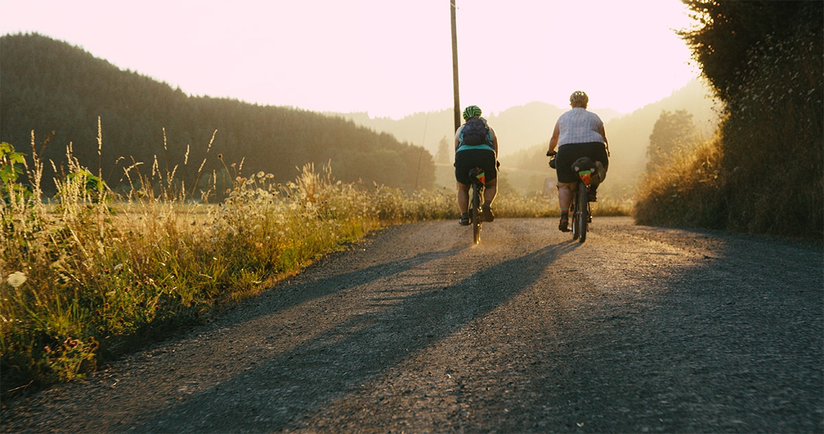 Kailey and Marley riding off into the sunset in Shimano Originals "All Bodies on Bikes"