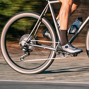Close-up of cyclist's foot on a bike pedal on rough terrain