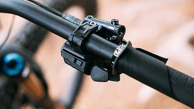 Shimano Deore bicycle gear shifter on a black handlebar