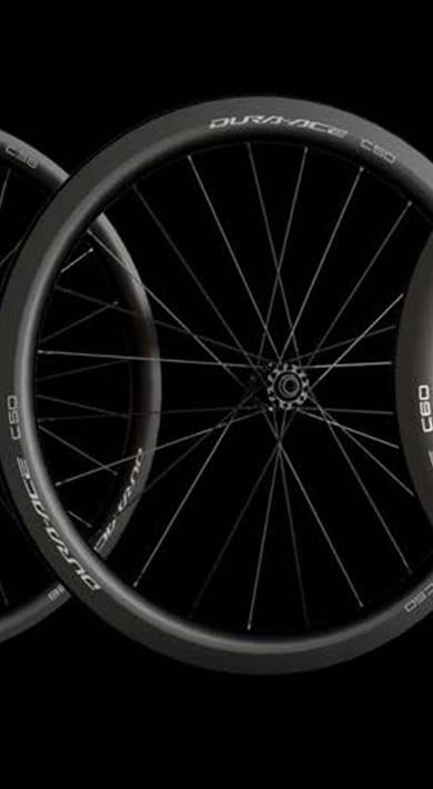 Three Shimano Dura-Ace C50 and C60 bike wheels displayed against a black background