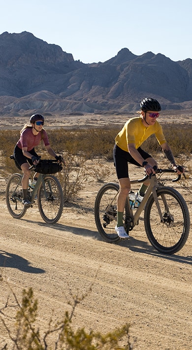 Cyclist carrying a bike over the shoulder while walking outdoors