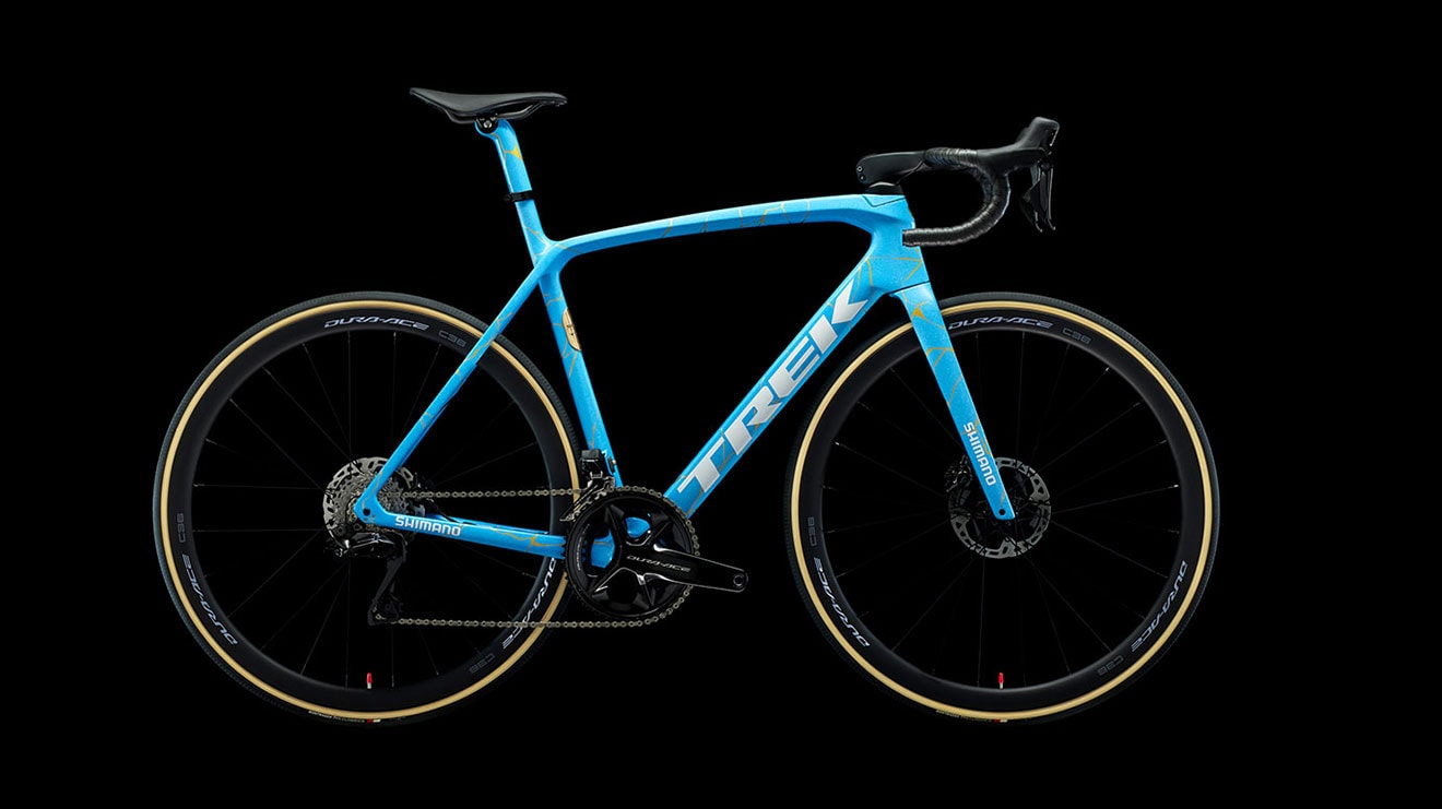 Blue and black Trek road bike with Shimano components on a black background