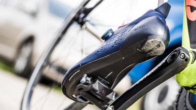 Close-up of a cycling shoe clipped into a bike pedal