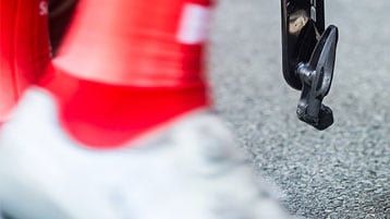 Close-up of a cyclist's shoe and pedal on a road