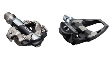 Two Shimano bike pedals, one XTR mountain bike clipless pedal and one Ultegra road bike clipless pedal.