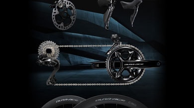 Bike components including gears, chain, and shifters on dark background