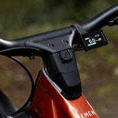 Close-up of an electric bicycle handlebar with a digital display.