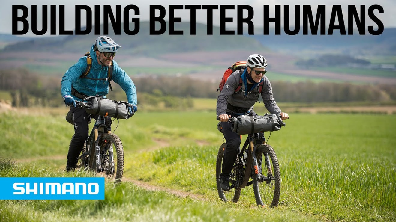 Two cyclists on a trail with 'Rewriting Labels' text.