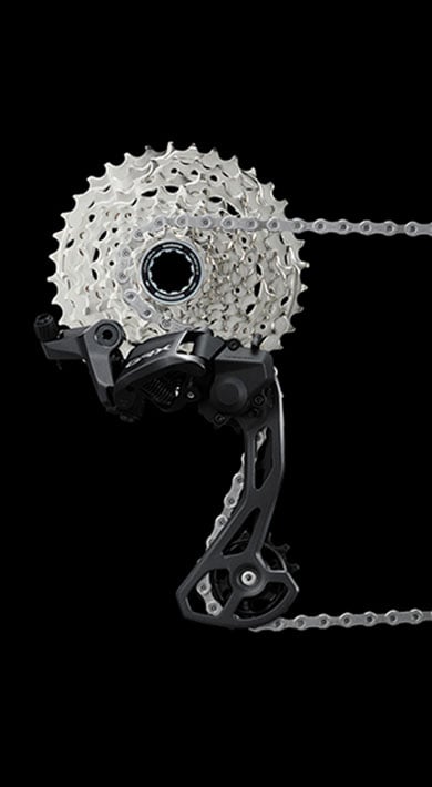 Shimano GRX crankset and cassette with chain on a black background