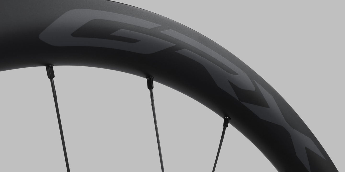 Close-up of a black GRX bicycle wheel with spokes