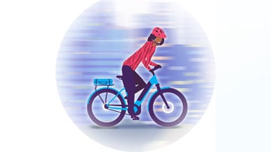 Illustration of a person riding a bike wearing a helmet and red jacket against a blurred background