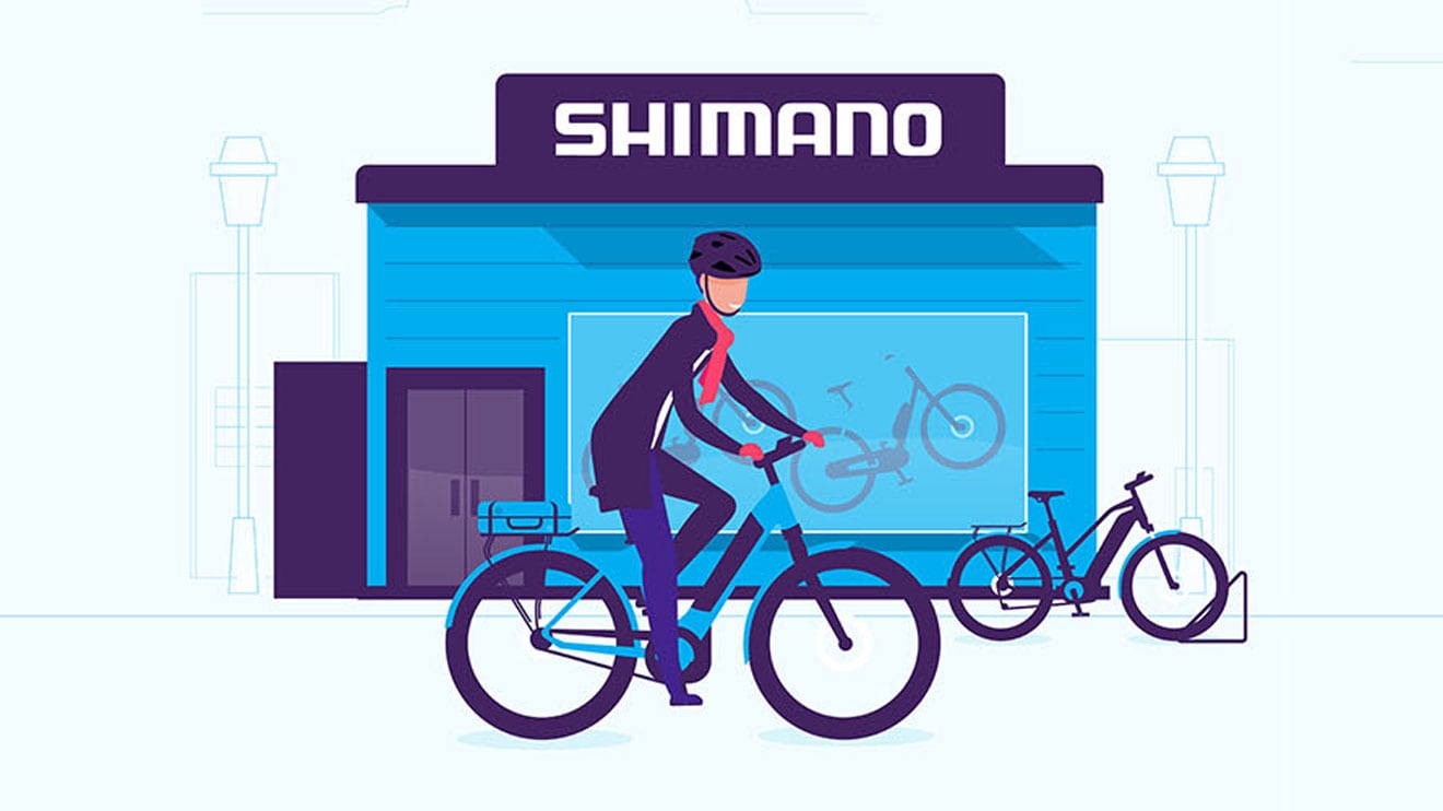 Illustration of a person riding a bicycle in front of a Shimano store