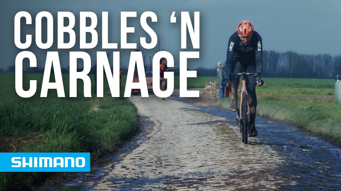 Cyclist riding on a cobblestone path with text 'Cobbles 'N Carnage' and Shimano logo