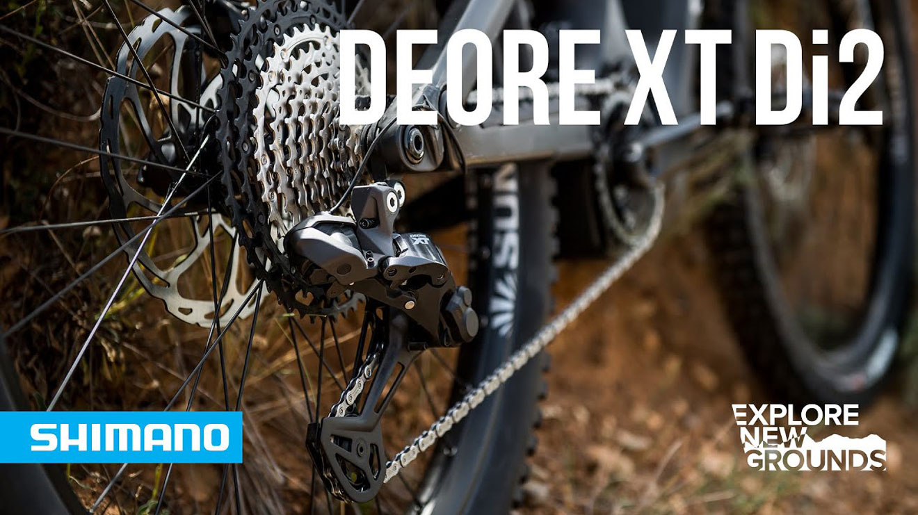 Deore XT Di2 derailleur on a bicycle with Shimano and Explore New Grounds logos.