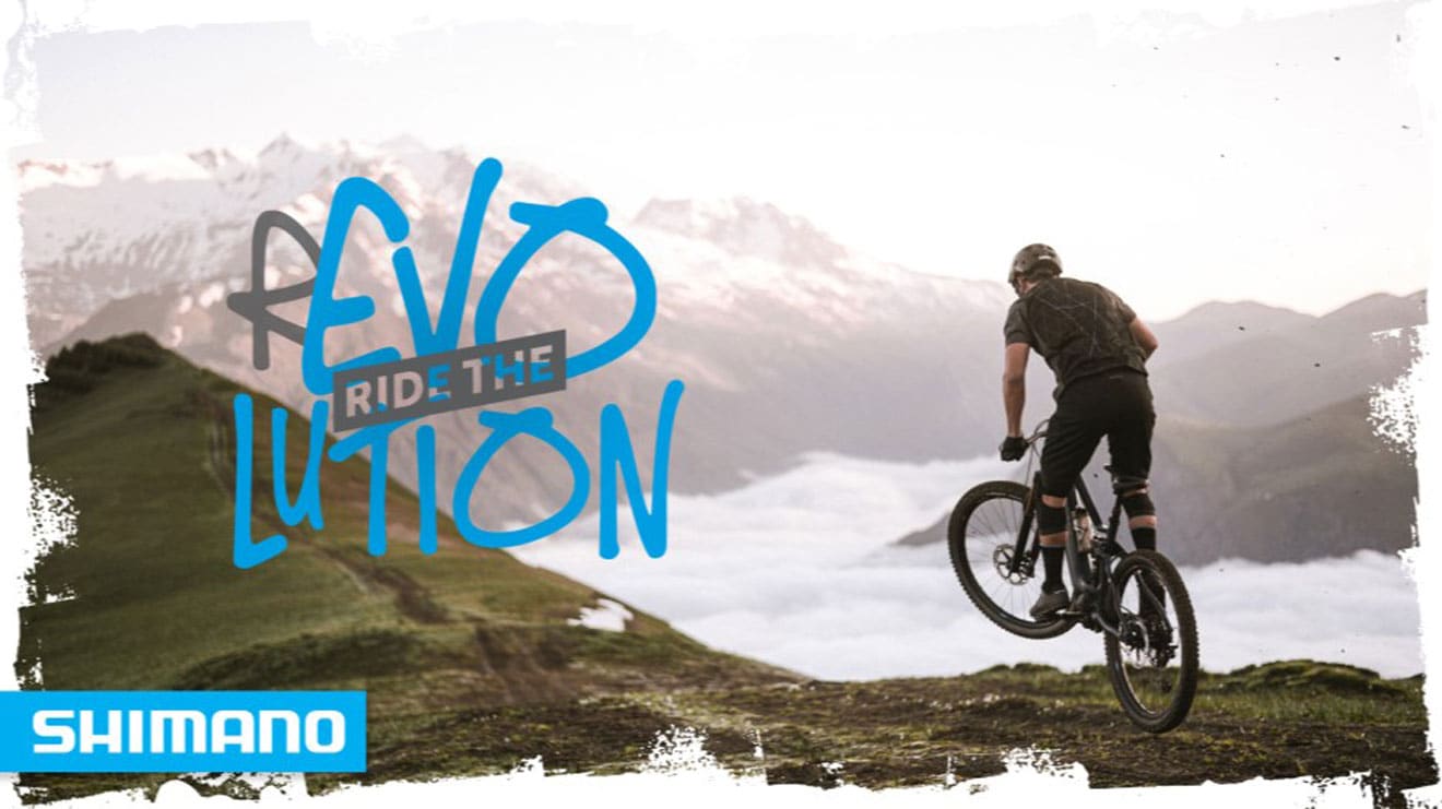 Cyclist on mountainside with the text 'Ride the Revolution'. Shimano logo in the corner.