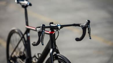 Black road bike with drop handlebars and red accents