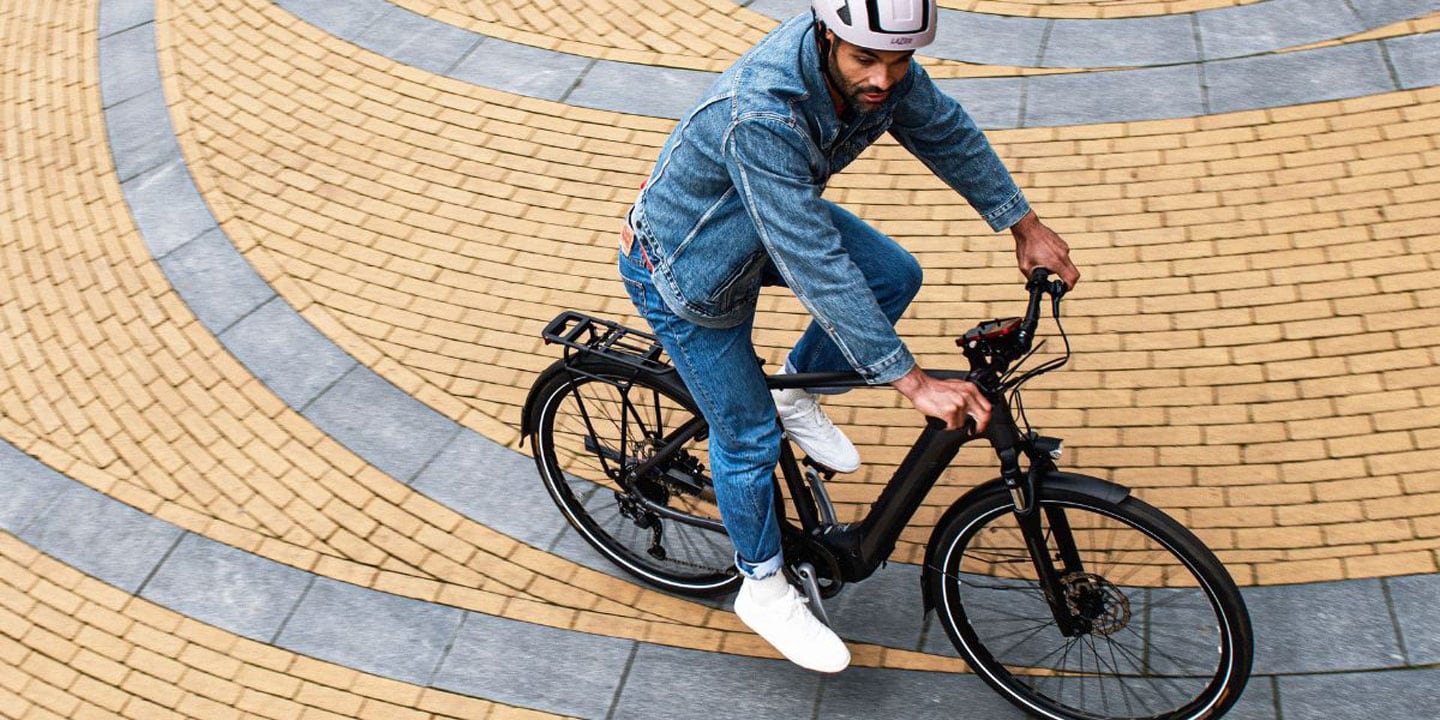 Person riding a bicycle on a circular brick path