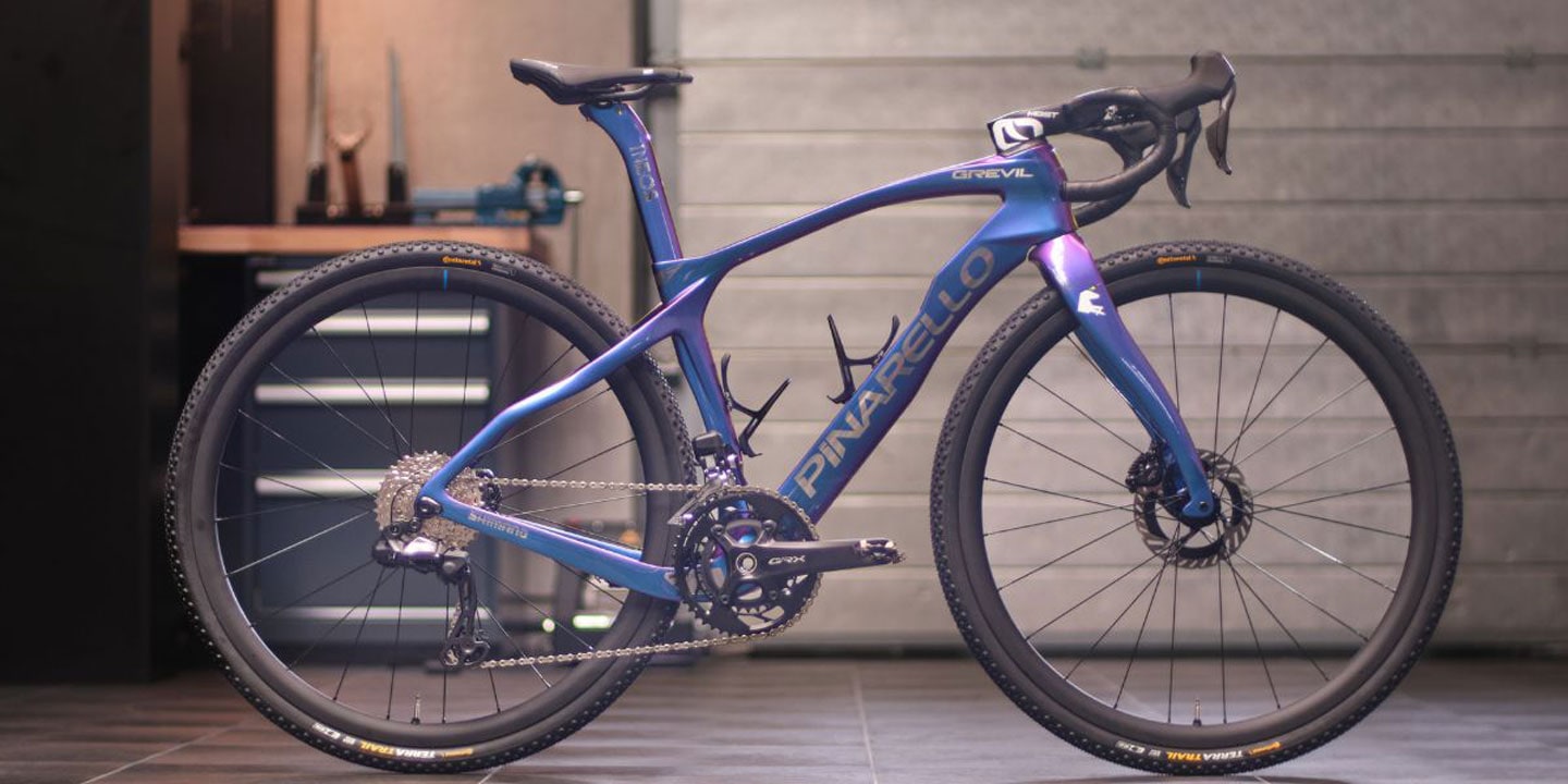 Pinarello gravel bike parked indoors in a workshop