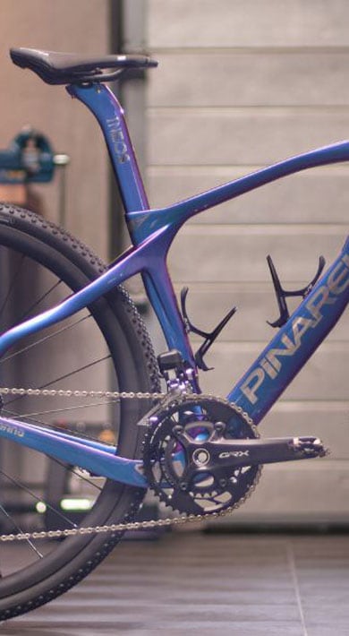 Pinarello gravel bike parked indoors in a workshop