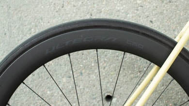 Close-up of a bicycle wheel with 'Ultegra C50' branding on the rim.