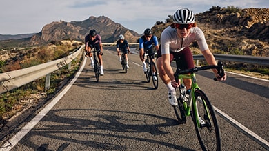 Group of bike riders riding road bikes down a road with Shimano 
