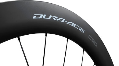 Close-up of a Dura-Ace C50 bicycle wheel with black spokes