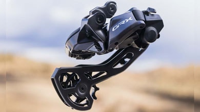 Close-up of a GRX bicycle derailleur against a blurred background