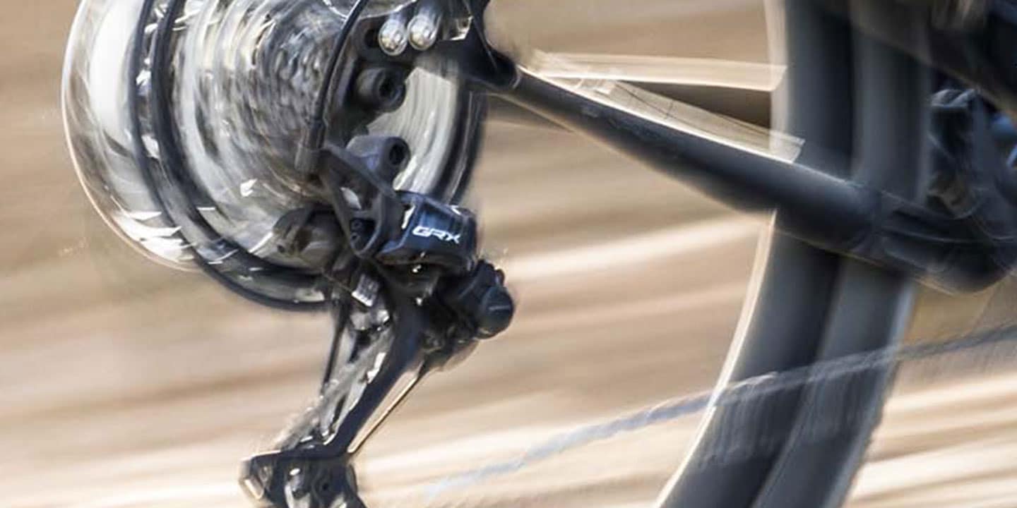 Close-up of a spinning bicycle wheel and derailleur in motion