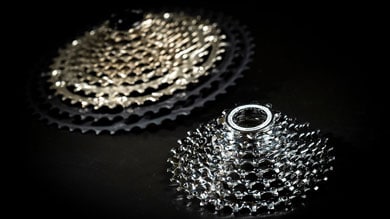 Two bike gear cassettes on a black background