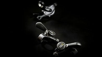 Close-up of Shimano bicycle gear shifters on a dark background