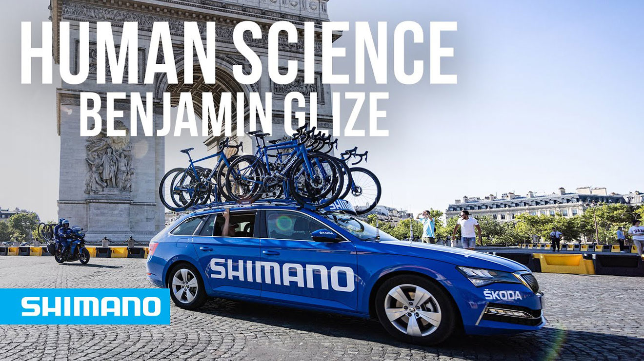 Blue Shimano car with bikes near Arc de Triomphe, text Human Science Benjamin Glize.