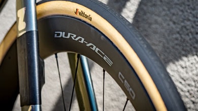 Close-up of a Vittoria tire and Dura-Ace wheel on a bicycle