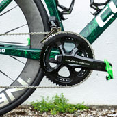 Close-up of a bicycle crankset and chain on a green bike