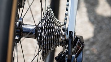 Close-up of a bicycle rear derailleur and gear cassette