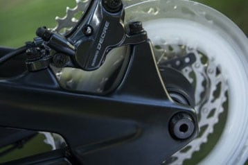 Close-up of bike disc brake and rotor in motion