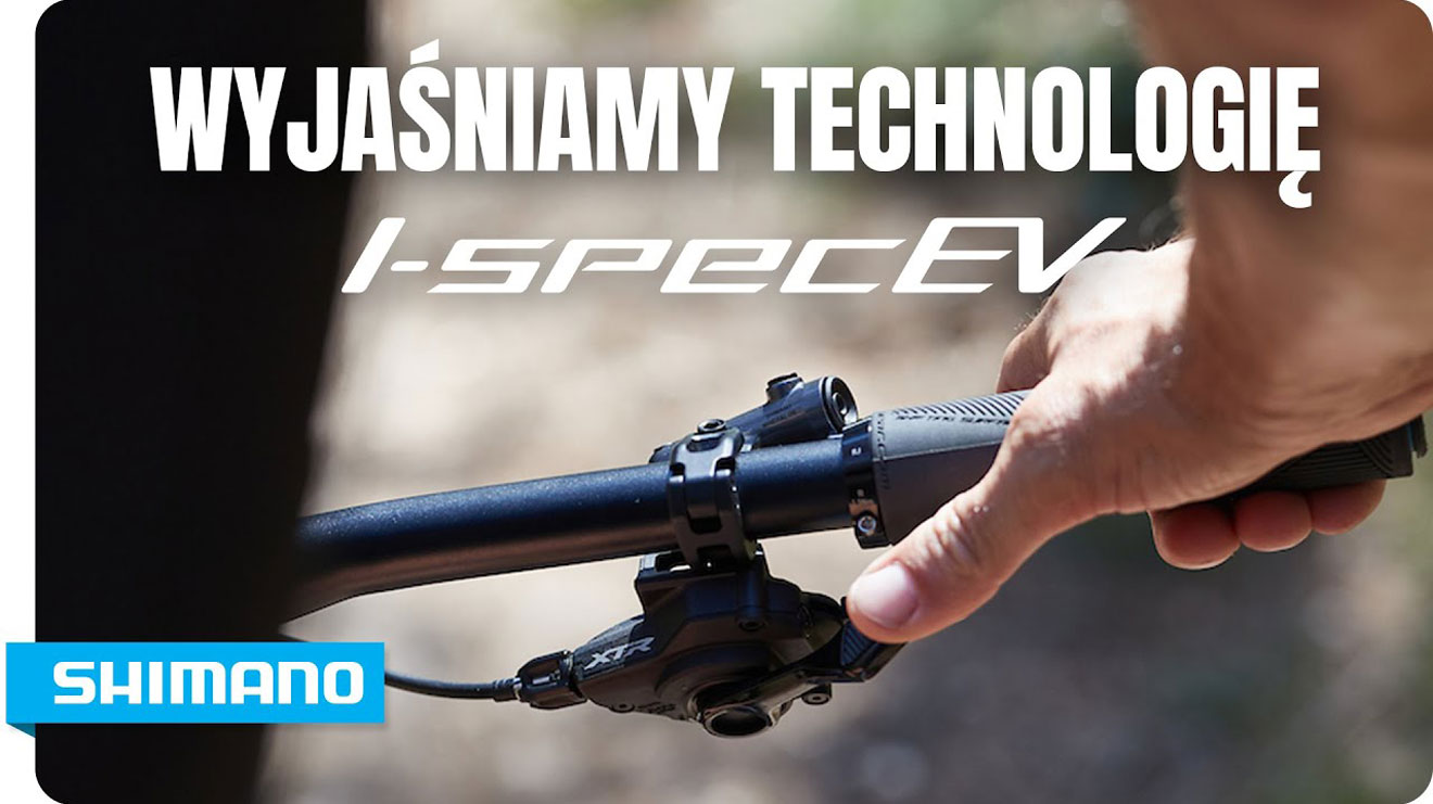 Ręka na kierownicy roweru z logo Shimano I-Spec EV.