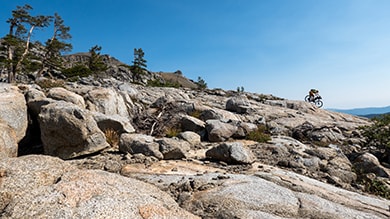 Shimano athlete Kurt Refsnider riding his XT MTB down a rock slab on the Orogenesis trail