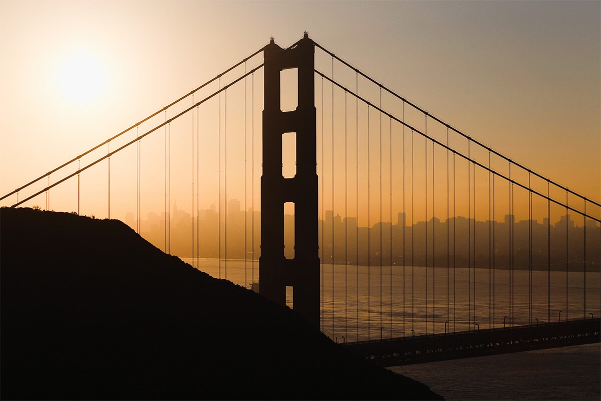 The Golden Gate Bridge in San Francisco at Sunset with orange glow 
